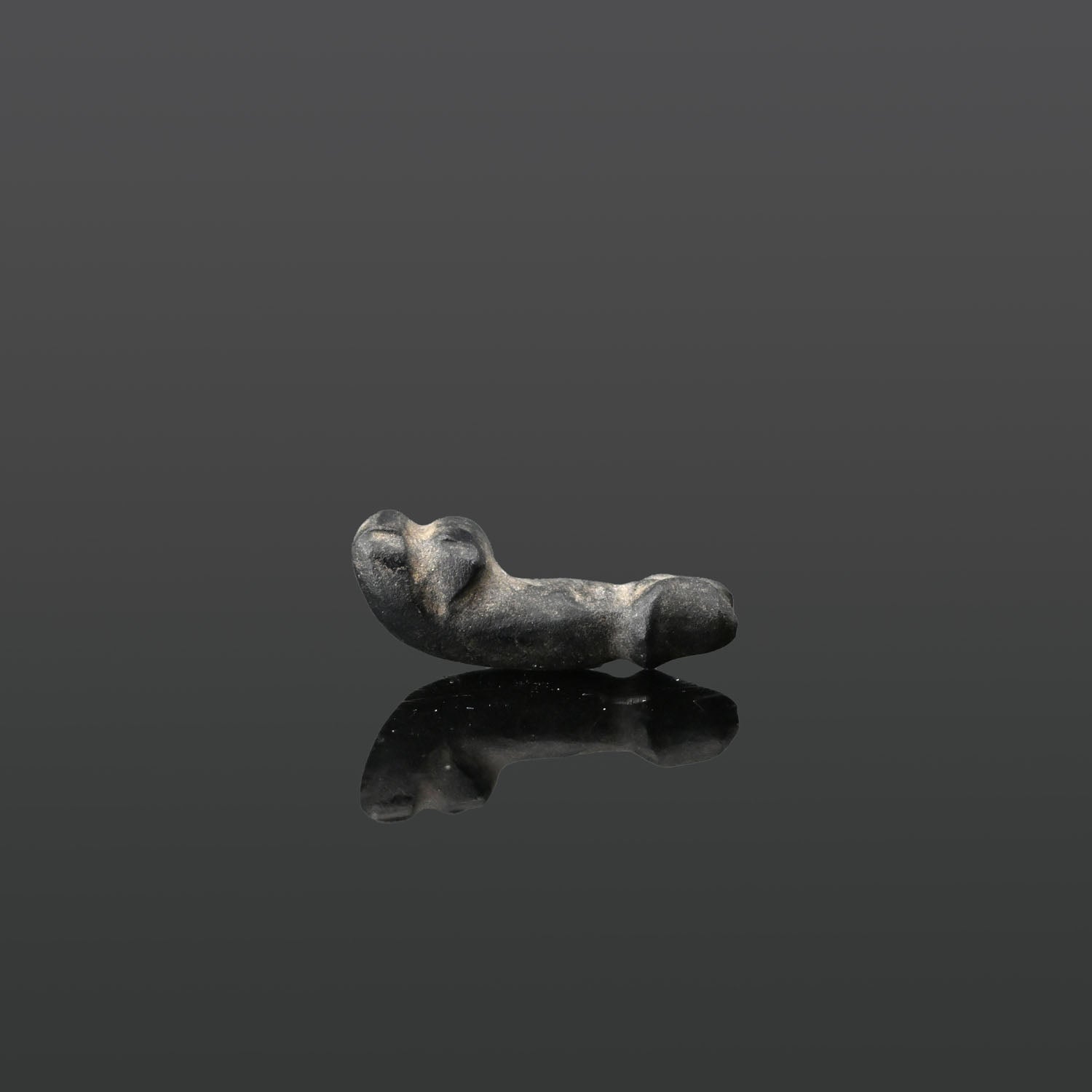 An Egyptian dark Serpentine Phallus Amulet, Late Period, ca. 664 - 332 BCE