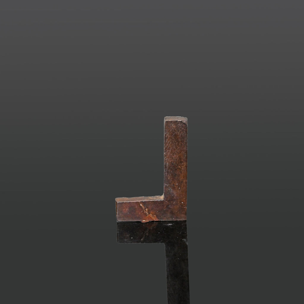 An Egyptian Hematite Set Square Amulet, Late Period, ca. 664 - 332 BCE