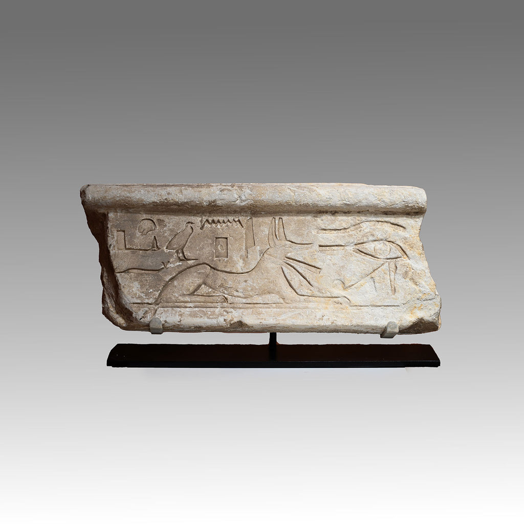 An Egyptian Limestone Relief fragment with Wedjet Eye and Anubis, New Kingdom, 18th Dynasty, ca. 1540 - 1292 BCE