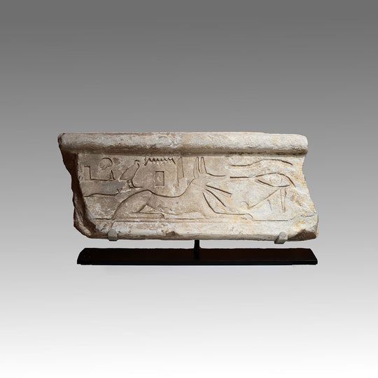 An Egyptian Limestone Relief fragment with Wedjet Eye and Anubis, New Kingdom, 18th Dynasty, ca. 1540 - 1292 BCE
