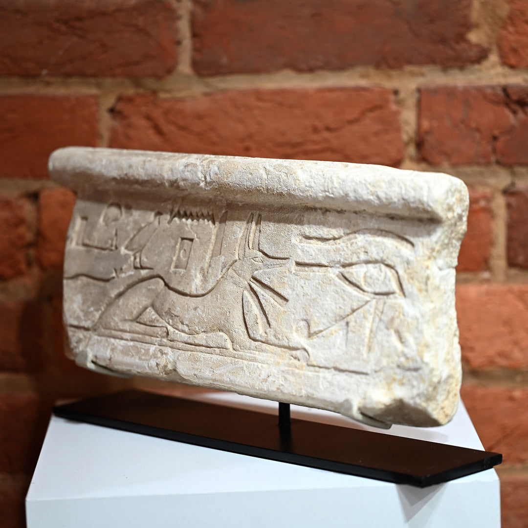 An Egyptian Limestone Relief fragment with Wedjet Eye and Anubis, New Kingdom, 18th Dynasty, ca. 1540 - 1292 BCE