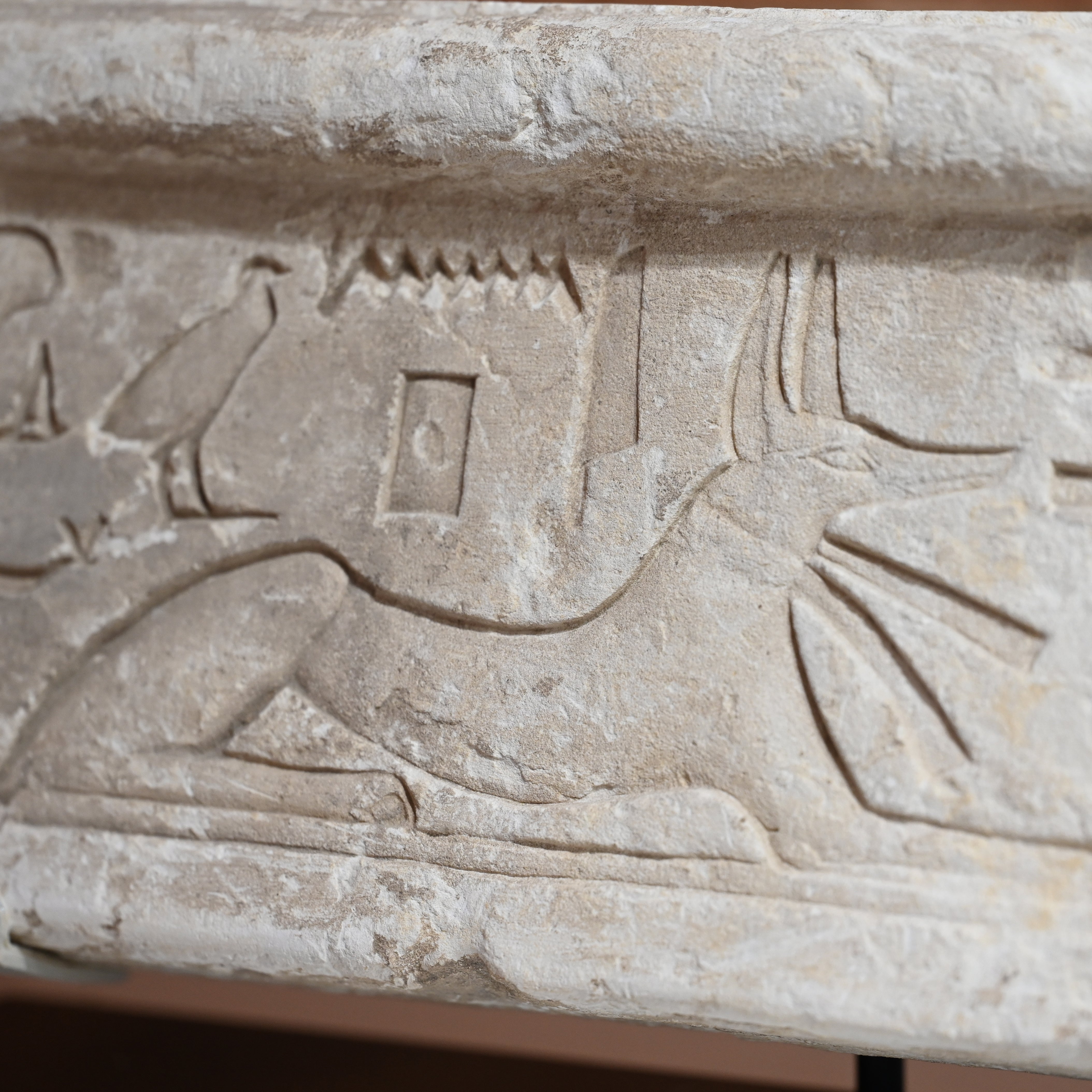 An Egyptian Limestone Relief fragment with Wedjet Eye and Anubis, New Kingdom, 18th Dynasty, ca. 1540 - 1292 BCE