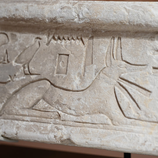 An Egyptian Limestone Relief fragment with Wedjet Eye and Anubis, New Kingdom, 18th Dynasty, ca. 1540 - 1292 BCE