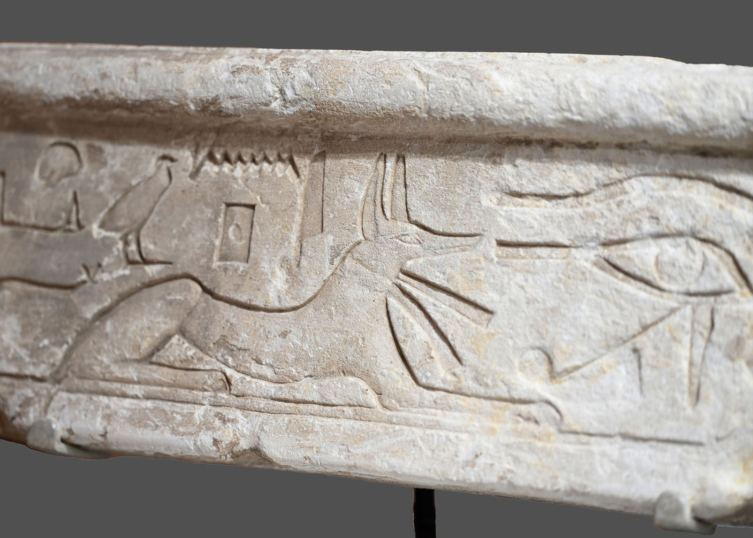 An Egyptian Limestone Relief fragment with Wedjet Eye and Anubis, New Kingdom, 18th Dynasty, ca. 1540 - 1292 BCE