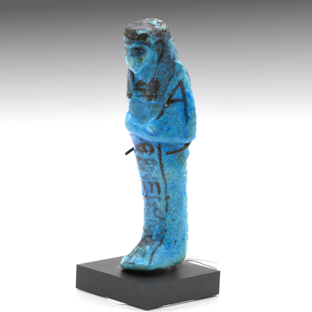 A Royal Egyptian bright blue glazed composition shabti for Princess AstEmKhebit, 21st Dynasty, Cache II, ca. 1069 - 945 BCE