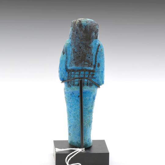 A Royal Egyptian bright blue glazed composition shabti for Princess AstEmKhebit, 21st Dynasty, Cache II, ca. 1069 - 945 BCE