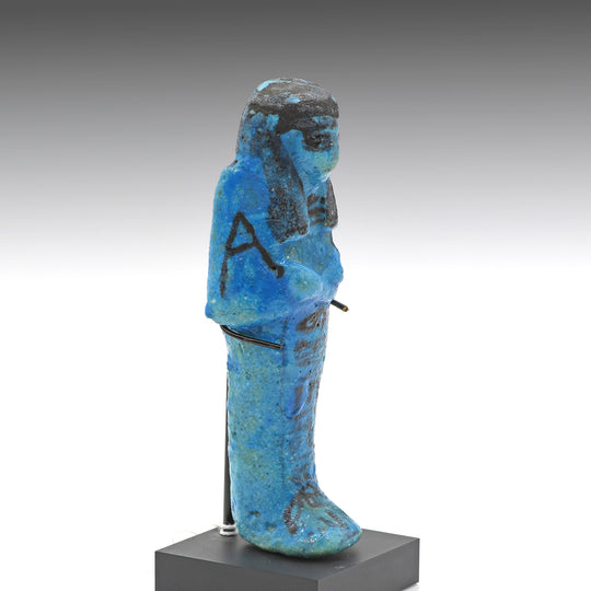 A Royal Egyptian bright blue glazed composition shabti for Princess AstEmKhebit, 21st Dynasty, Cache II, ca. 1069 - 945 BCE