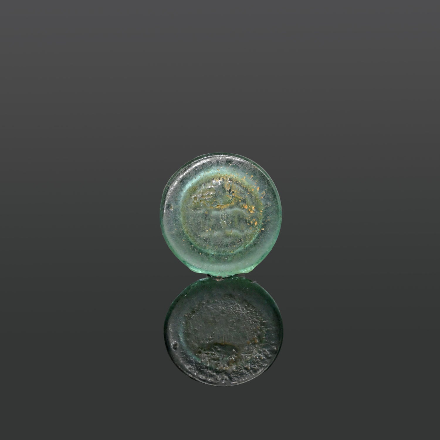 An Islamic Glass Coin Weight, ca. 9th - 11th century CE