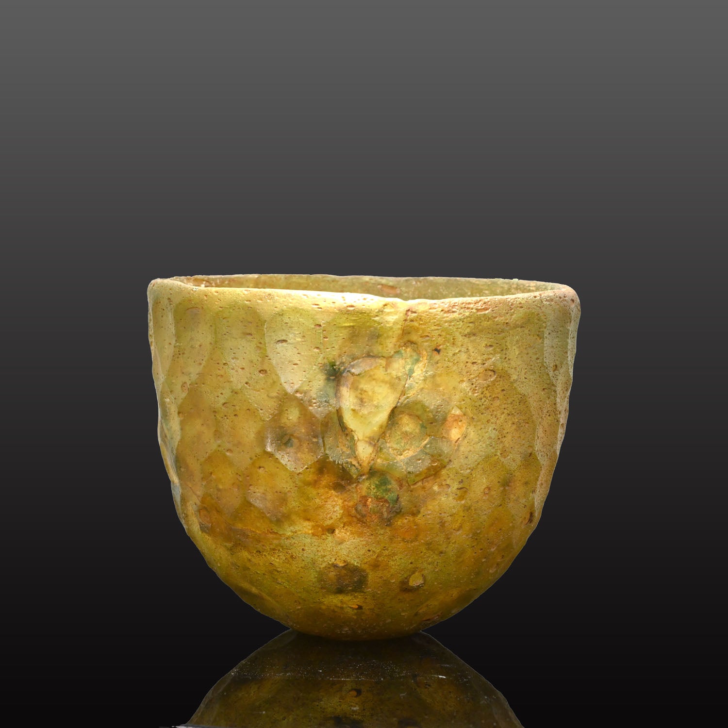 A Sasanian Green Cut-Glass Bowl with Hexagonal Facets, ca. 5th - 6th century CE