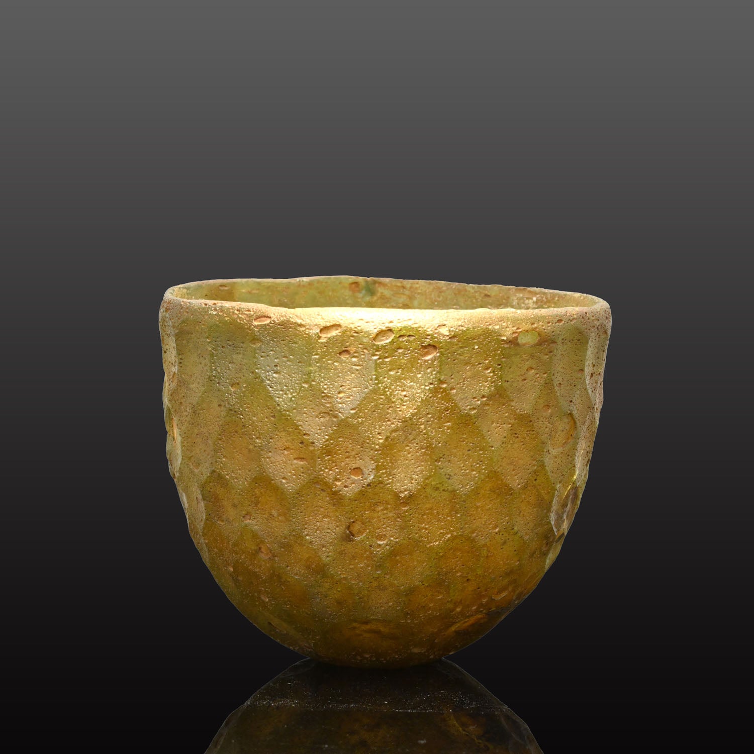 A Sasanian Green Cut-Glass Bowl with Hexagonal Facets, ca. 5th - 6th century CE