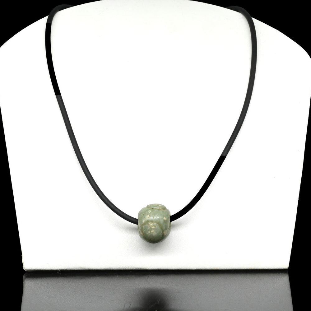 A Maya Jade Bead, Classic Period, ca. 500 - 900 CE