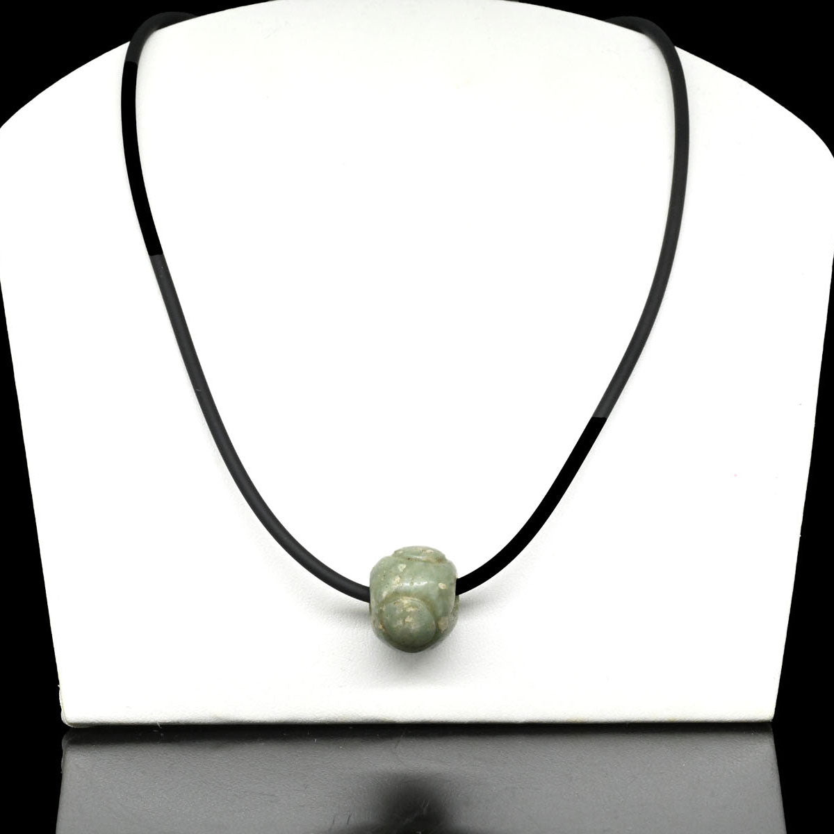 A Maya Jade Bead, Classic Period, ca. 500 - 900 CE