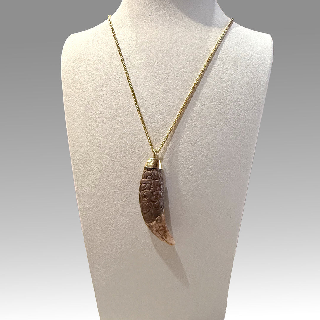 A rare and exceptional Maya Decorated Jaguar Tooth Pendant, Classic Period, ca. 500 - 800 CE