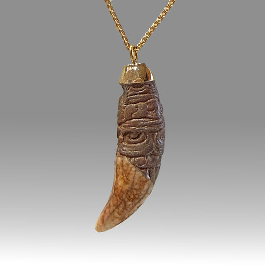 A rare and exceptional Maya Decorated Jaguar Tooth Pendant, Classic Period, ca. 500 - 800 CE