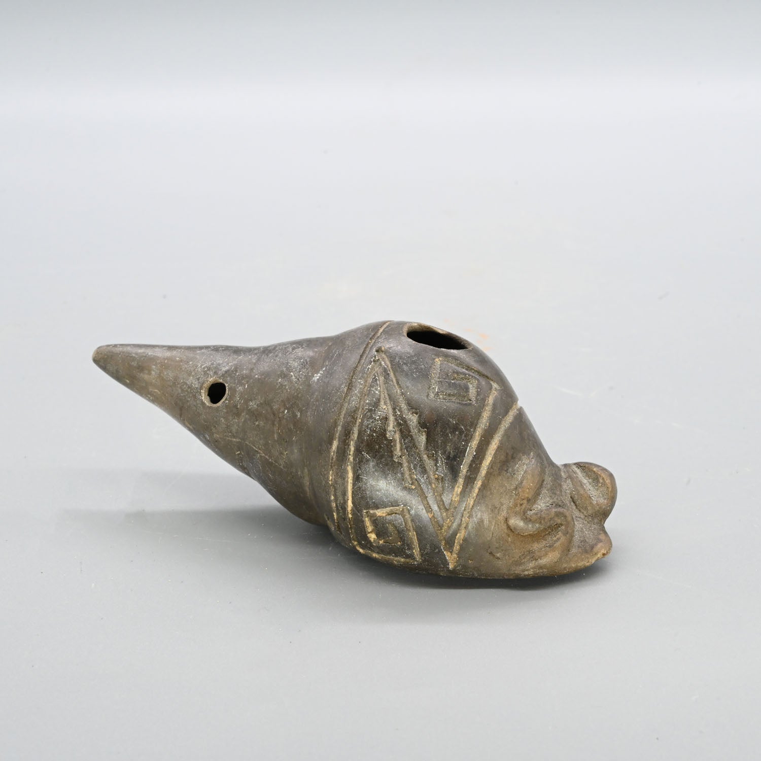 A Narino Pottery Shell Form Ocarina, Classical Period, ca. 500 - 1000 CE