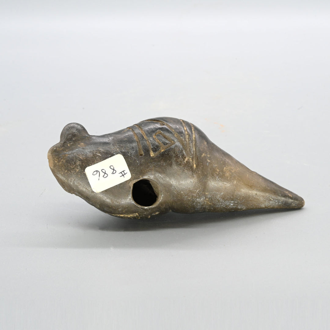 A Narino Pottery Shell Form Ocarina, Classical Period, ca. 500 - 1000 CE