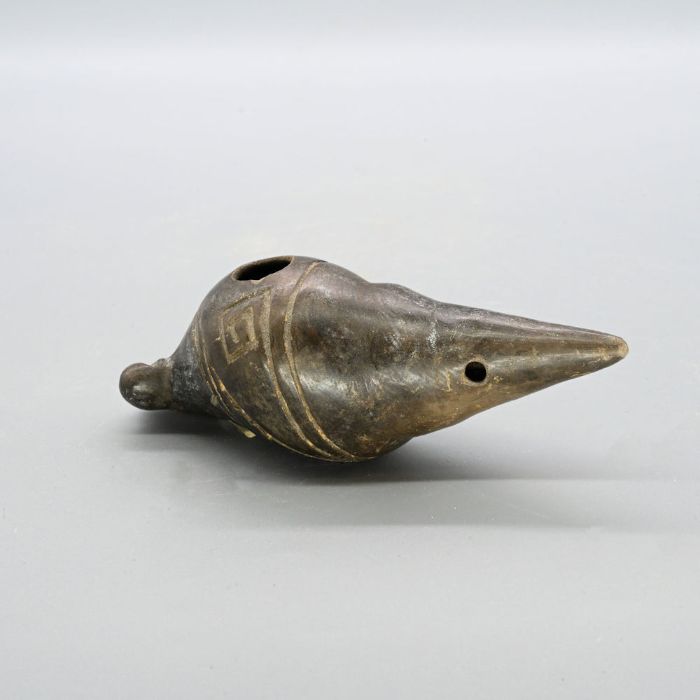 A Narino Pottery Shell Form Ocarina, Classical Period, ca. 500 - 1000 CE