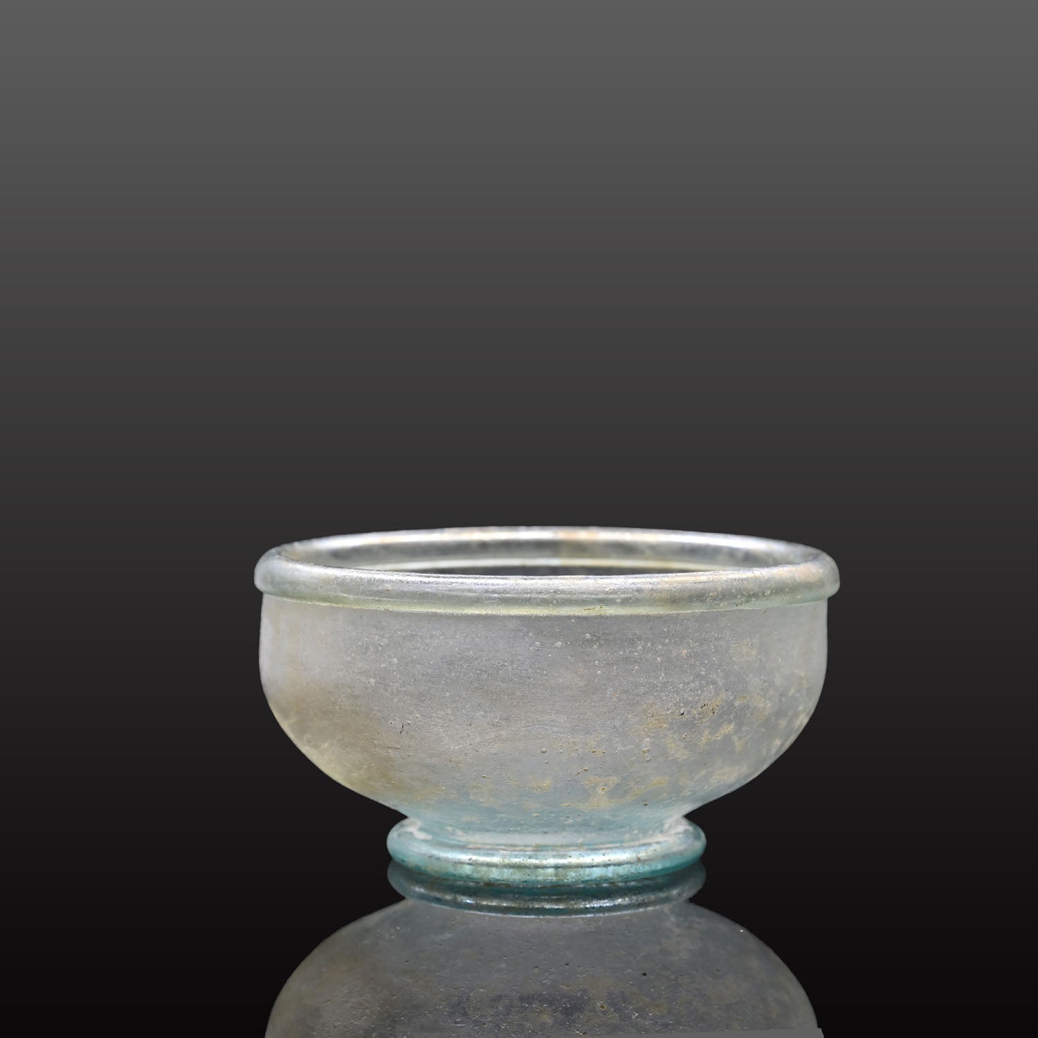 A small Roman Blue-Green Glass Bowl with Foot, Roman Imperial Period, ca. 3rd century CE