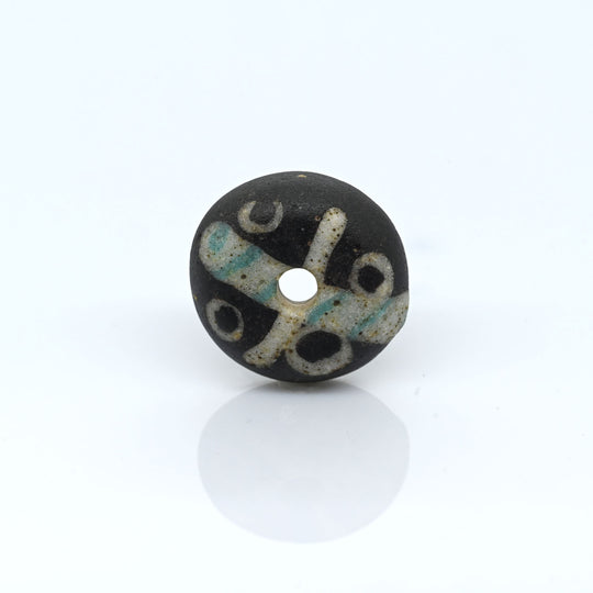 A Roman Decorated Glass Spindle Whorl,  Roman Imperial Period, ca. 2nd - 3rd century CE