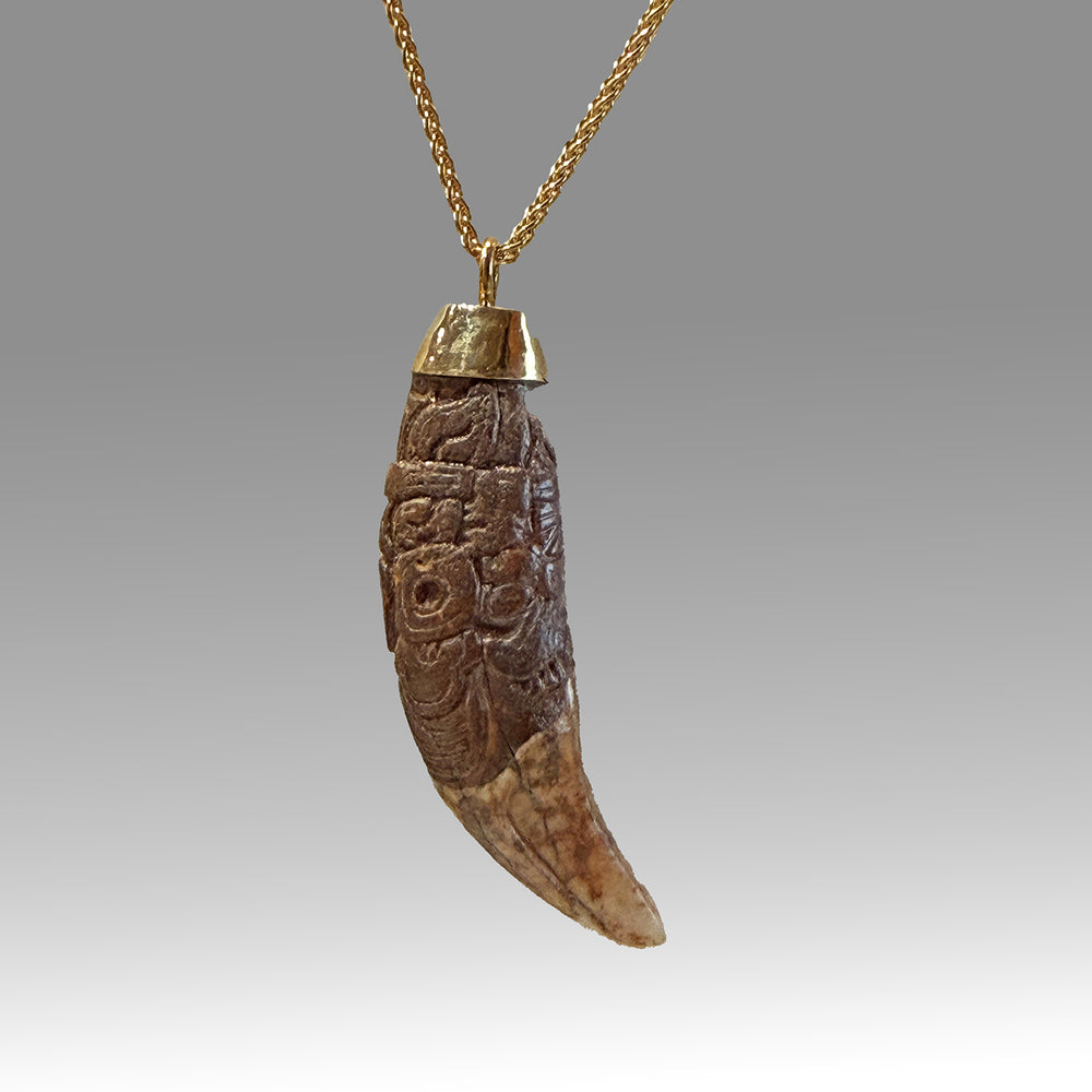 A rare and exceptional Maya Decorated Jaguar Tooth Pendant, Classic Period, ca. 500 - 800 CE