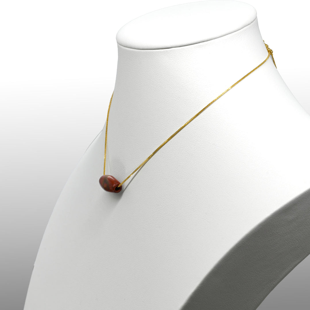 A Near Eastern Red Jasper Bead Pendant, Roman Imperial Period, ca.  1st - 2nd century CE