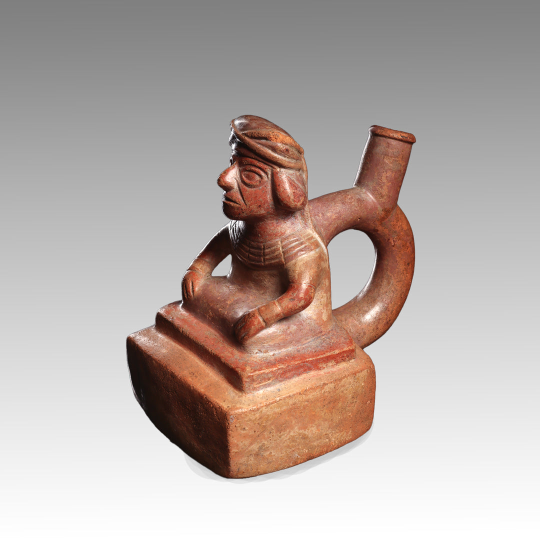 A Moche Terracotta Stirrup-Spout Vessel Depicting a Seated Dignitary, Moche II, ca. 300 - 500 CE