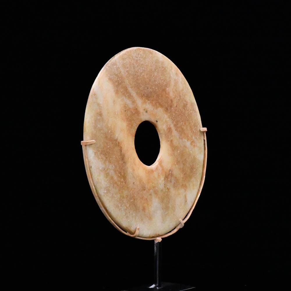 A Chinese Mottled Nephrite Jade Bi Disc, Late Neolithic Period, <br><em>ca. 3000 - 2000 BCE</em>