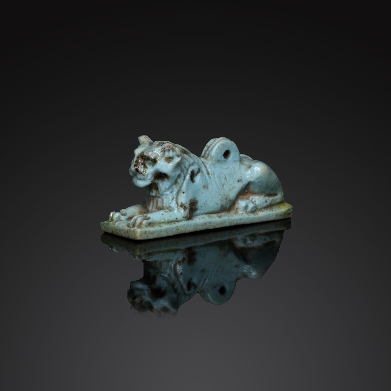 An Egyptian Faience Amulet of a Recumbent Lion, Ptolemaic Period, ca. 332 - 30 BCE