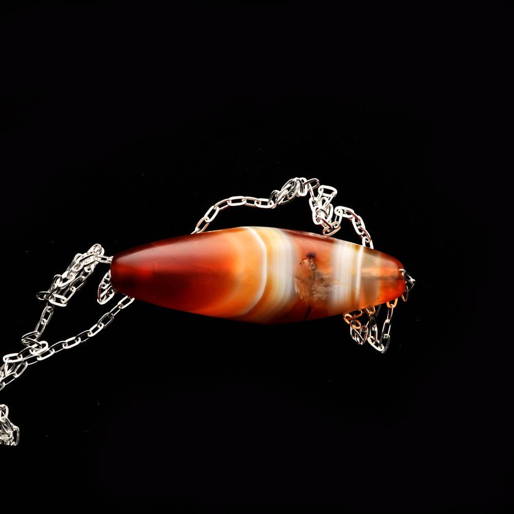 A Western Asiatic Banded Agate Bead Pendant, ca 1st millennium BCE