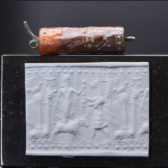 A Neo-Assyrian Brown Chalcedony Cylinder Seal, ca. 883 - 612 BCE