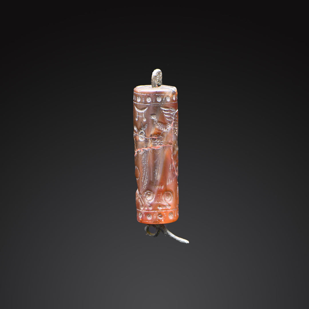 A Neo-Assyrian Brown Chalcedony Cylinder Seal, ca. 883 - 612 BCE