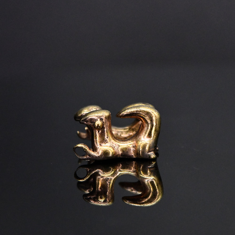 A Sinu Tumbaga Double-Tailed Lizard Pendant, Colombia, ca. 500 - 1000 CE