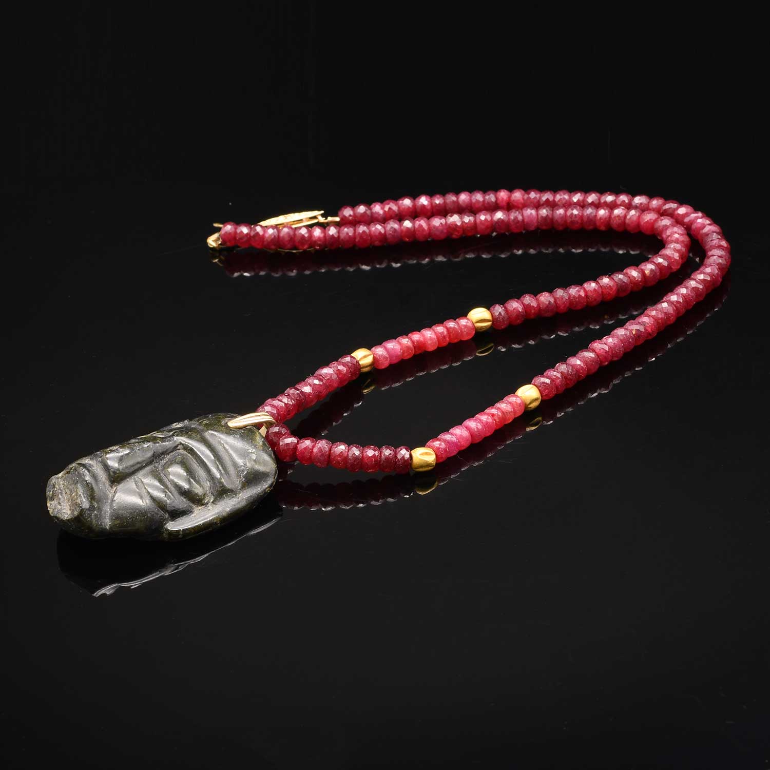 A Costa Rican Jade Pendant Mask, ca. 300 - 500 CE, restrung on ruby necklace