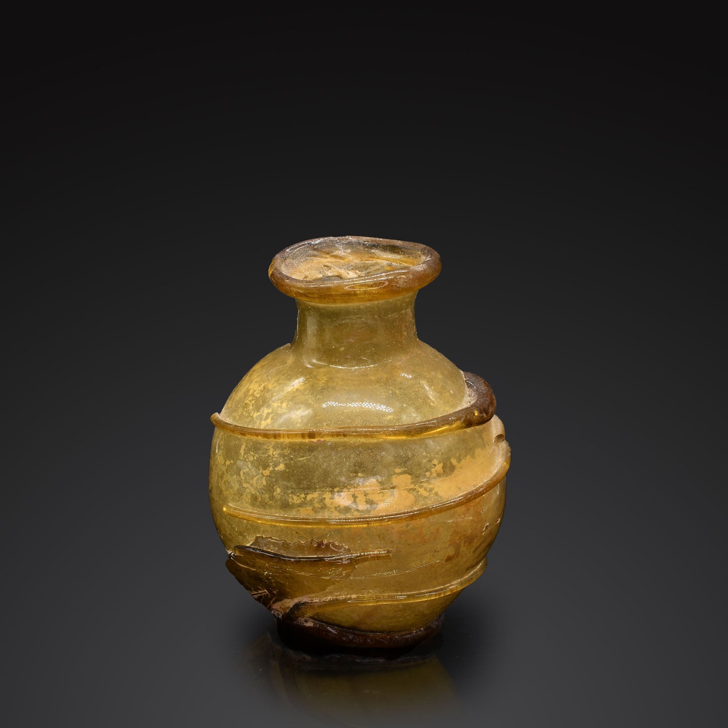 A Roman Amber Glass Bottle, ca. 2nd - 3rd century CE