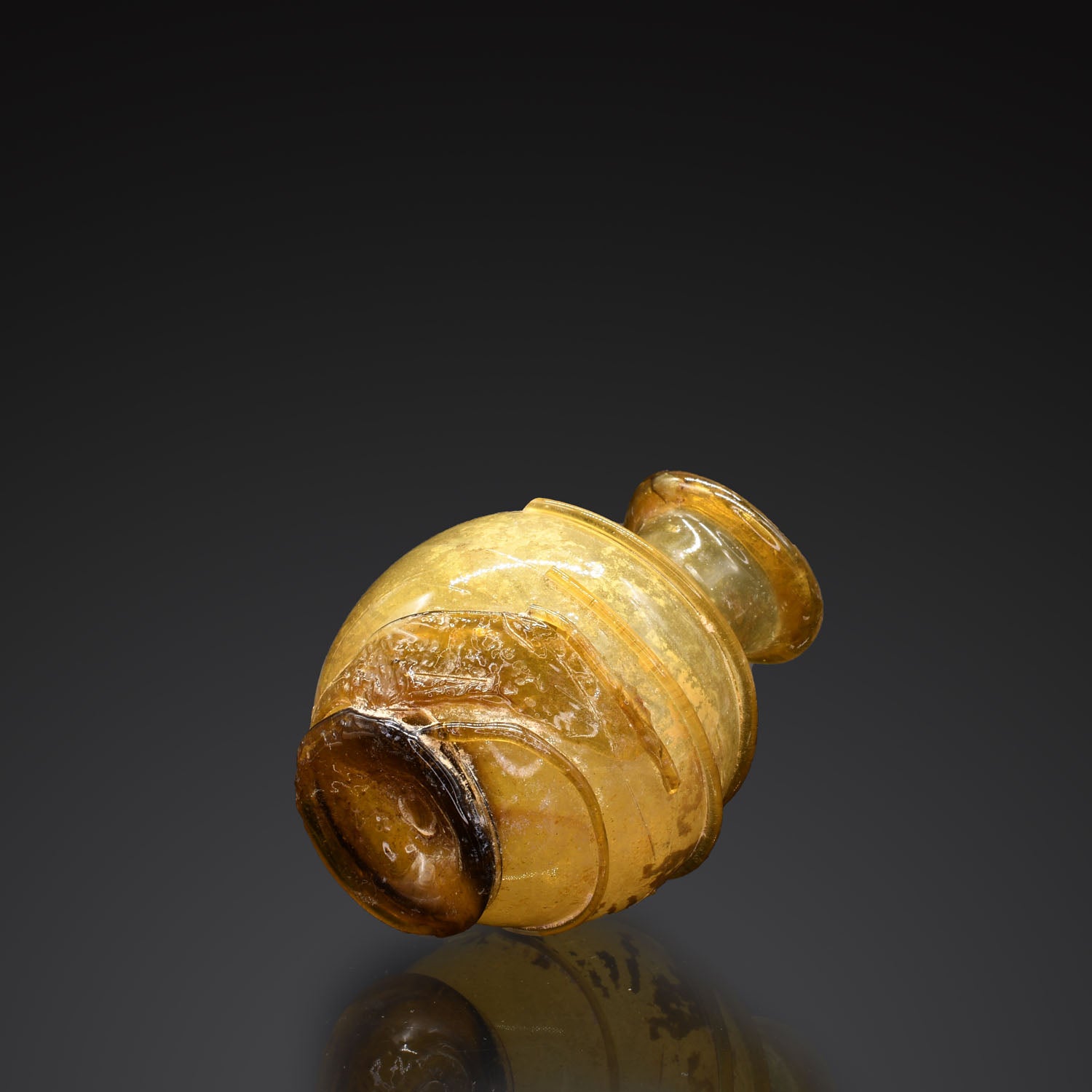 A Roman Amber Glass Bottle, ca. 2nd - 3rd century CE